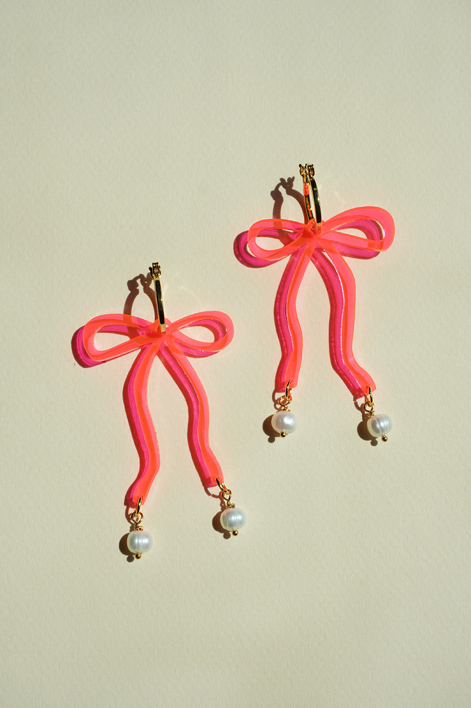 Bow Hoop Earrings in Neon Pink