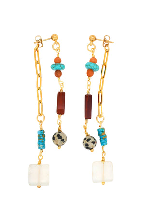 A pair of gold-toned dangle earrings featuring turquoise, terracotta, black-and-white mottled beads, and a large white square bead at the bottom, displayed on a clean white background.