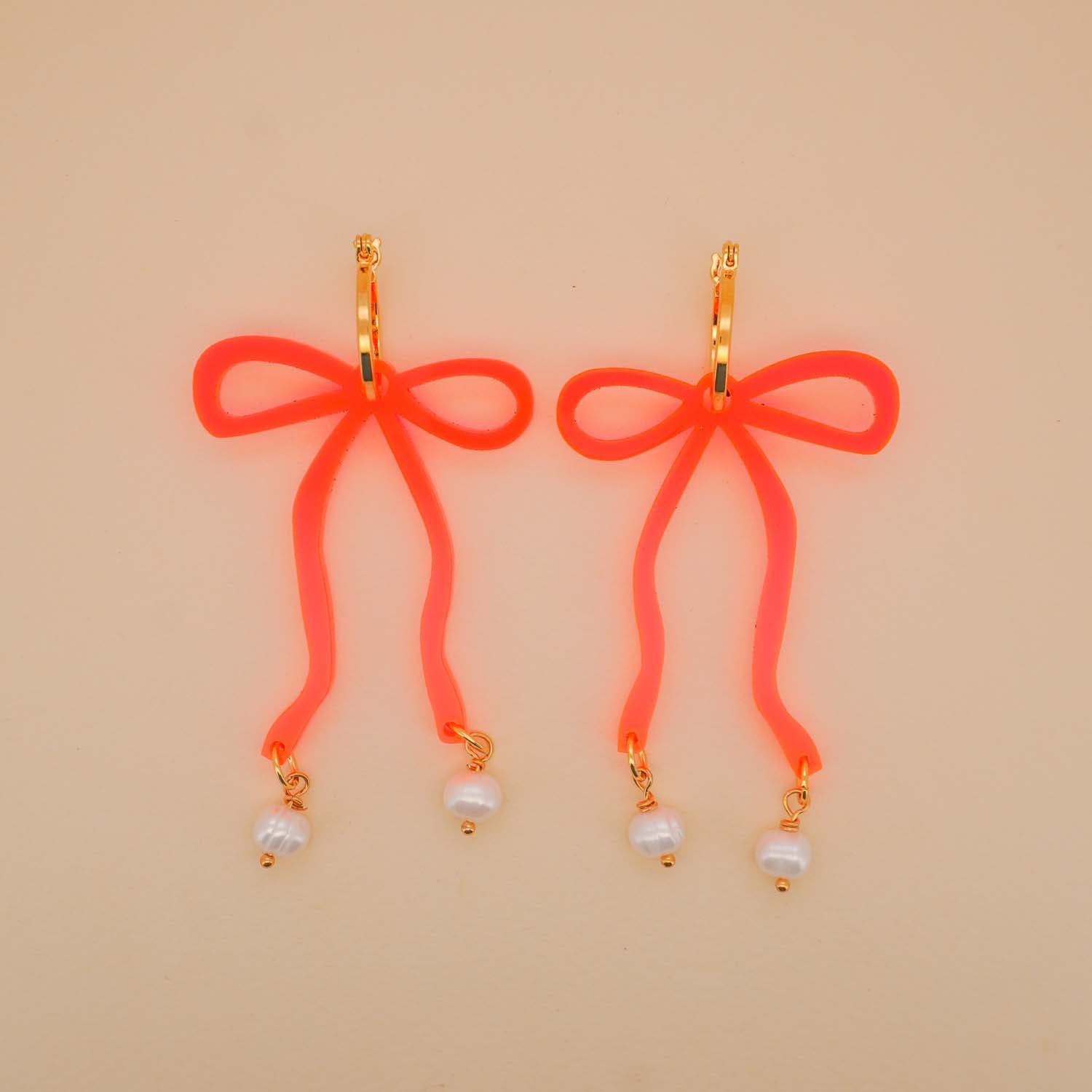 Bow Hoop Earrings in Neon Pink